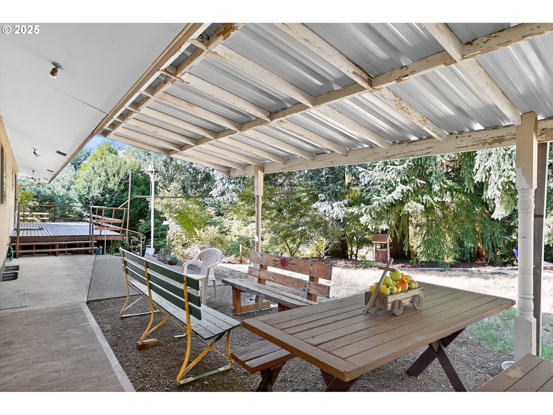 9479 Southeast Hillcrest Road Happy Valley, OR 97086 - Photo 26 of 30 a view of a patio with table and chairs and couches with wooden floor