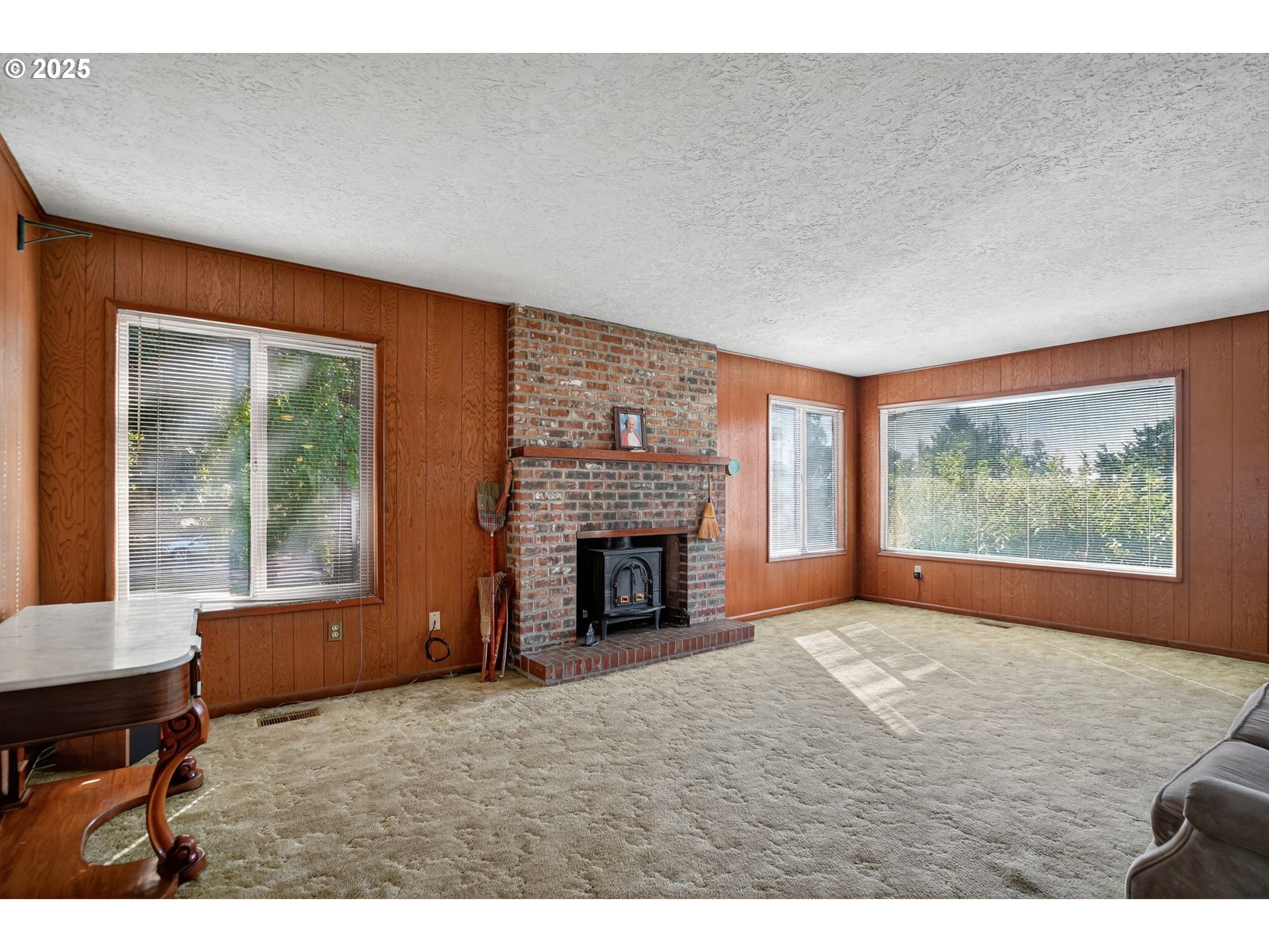 9479 Southeast Hillcrest Road Happy Valley, OR 97086 - Photo 6 of 30 a view of an empty room with a fireplace and a window