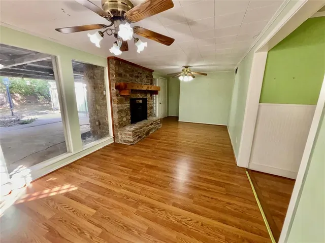a kitchen with wooden floors and white stainless steel appliances