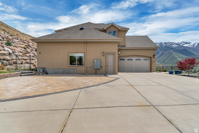 2543 East 700 South Springville, UT 84663 - Photo 8 of 73 View of side of property featuring stucco siding, a garage, a mountain view, roof with shingles, and concrete driveway