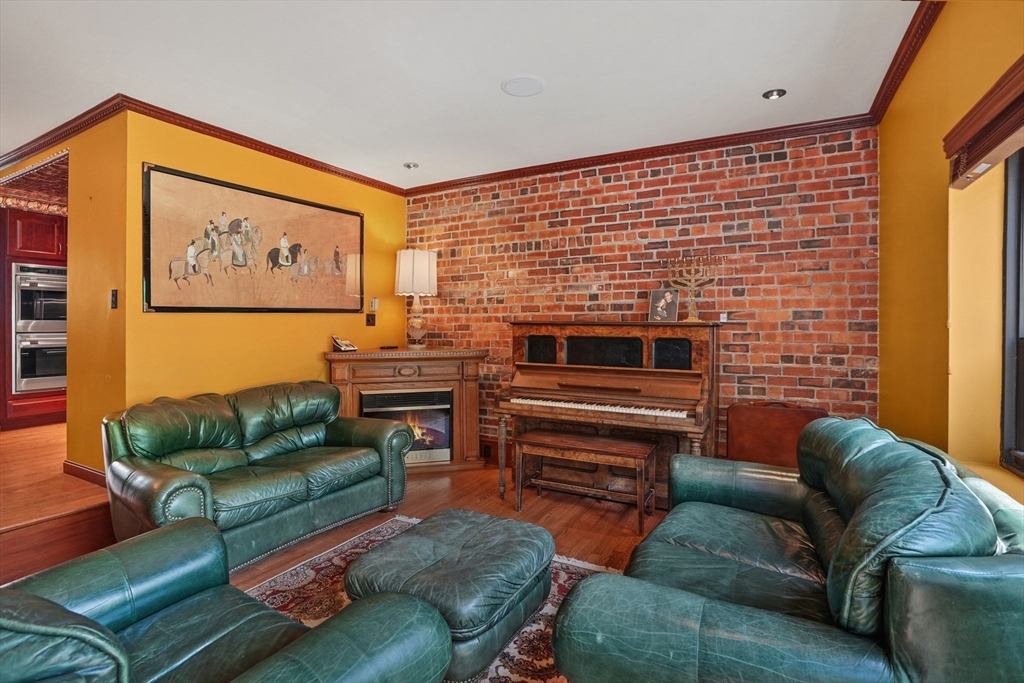131 Perkins Street, Unit 131 Boston, MA 02130 - Photo 4 of 21 a living room with furniture and a flat screen tv