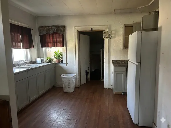 a kitchen with a refrigerator and a sink