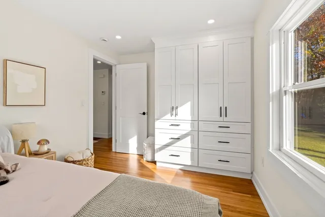 a spacious bedroom with a bed and a dresser