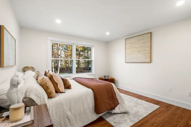 a bed sitting in a bedroom next to a window
