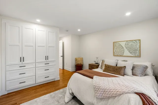 a bedroom with a bed and cabinet