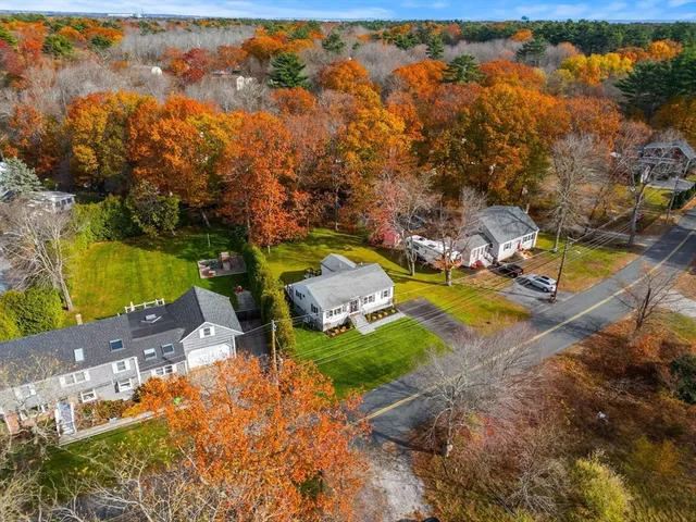 an aerial view of a houses with yard