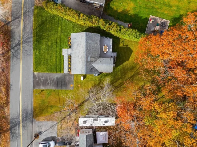 aerial view of a house with a yard