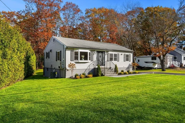 a front view of house with yard and green space