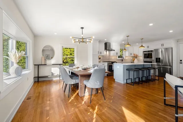 a dining room with furniture and wooden floor