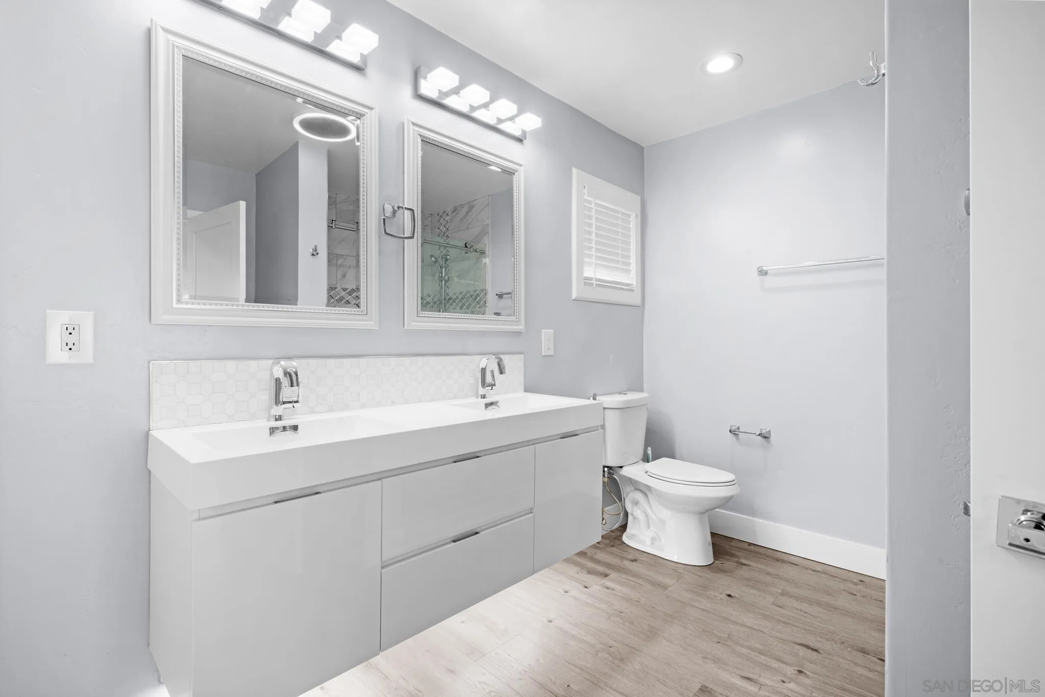 1908 Washington Street Lemon Grove, CA 91945 - Photo 13 of 54 a bathroom with a toilet sink and mirror