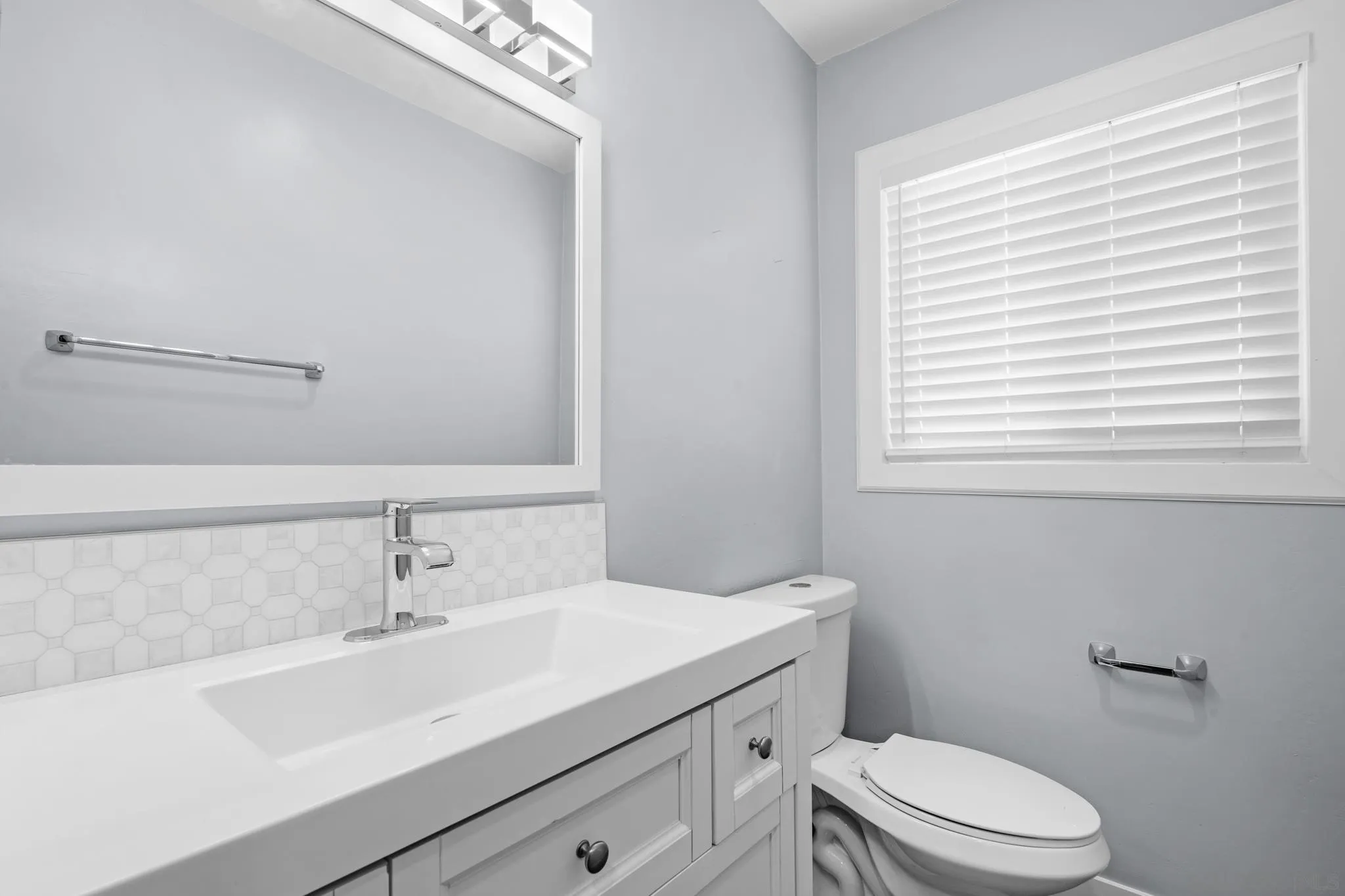1908 Washington Street Lemon Grove, CA 91945 - Photo 18 of 54 a bathroom with a sink a toilet and a window