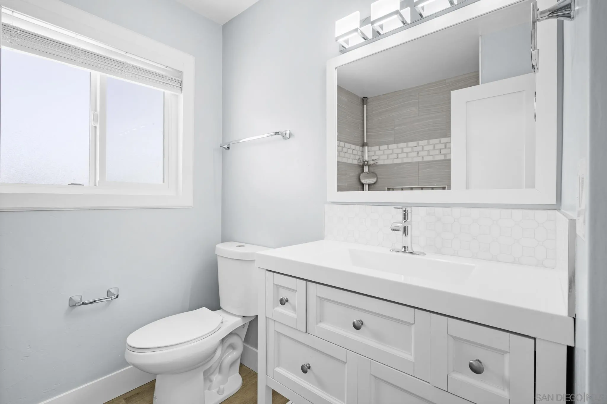 1908 Washington Street Lemon Grove, CA 91945 - Photo 22 of 54 a bathroom with a toilet sink and mirror