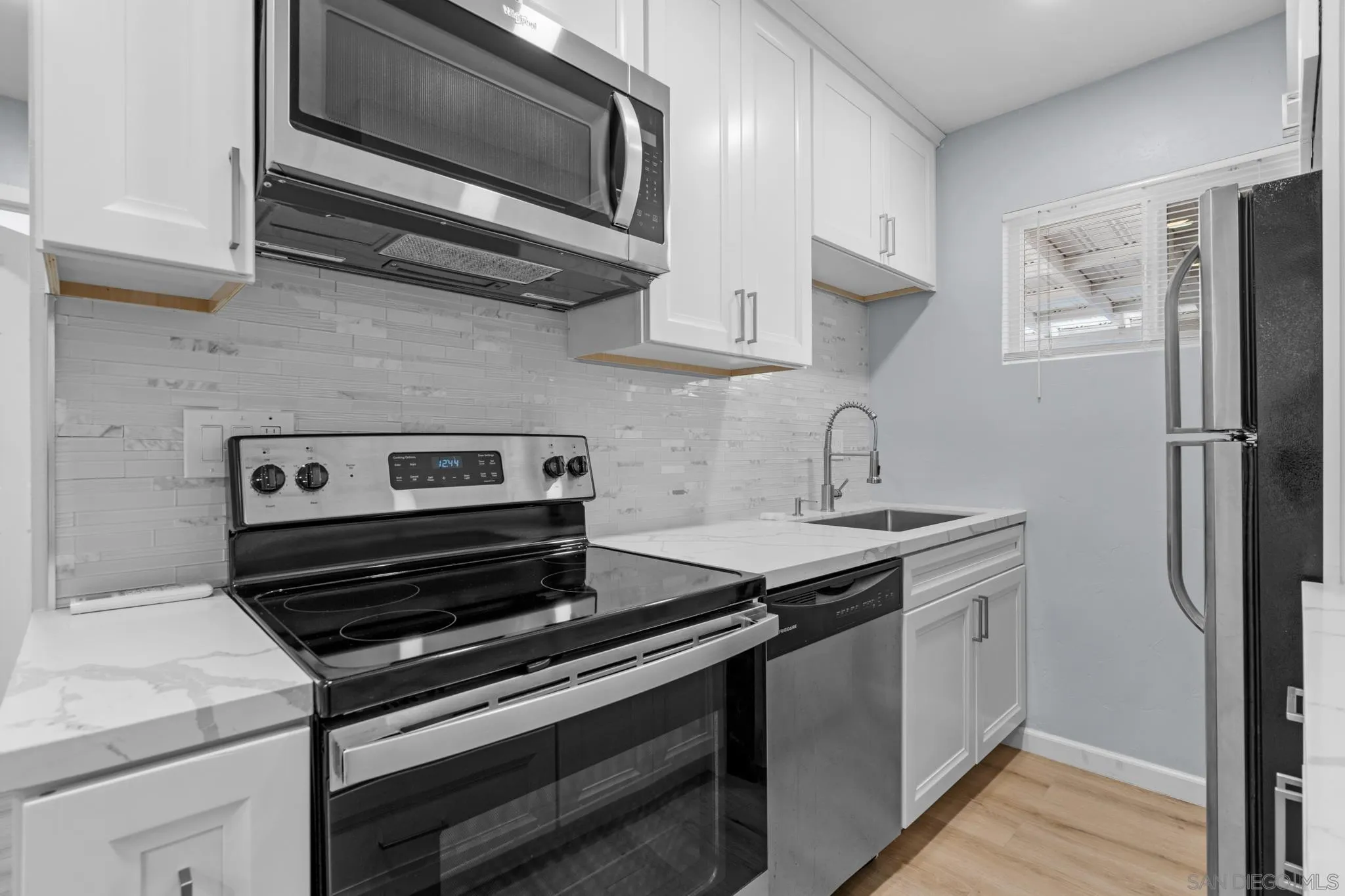 1908 Washington Street Lemon Grove, CA 91945 - Photo 26 of 54 a kitchen with a stove microwave and sink