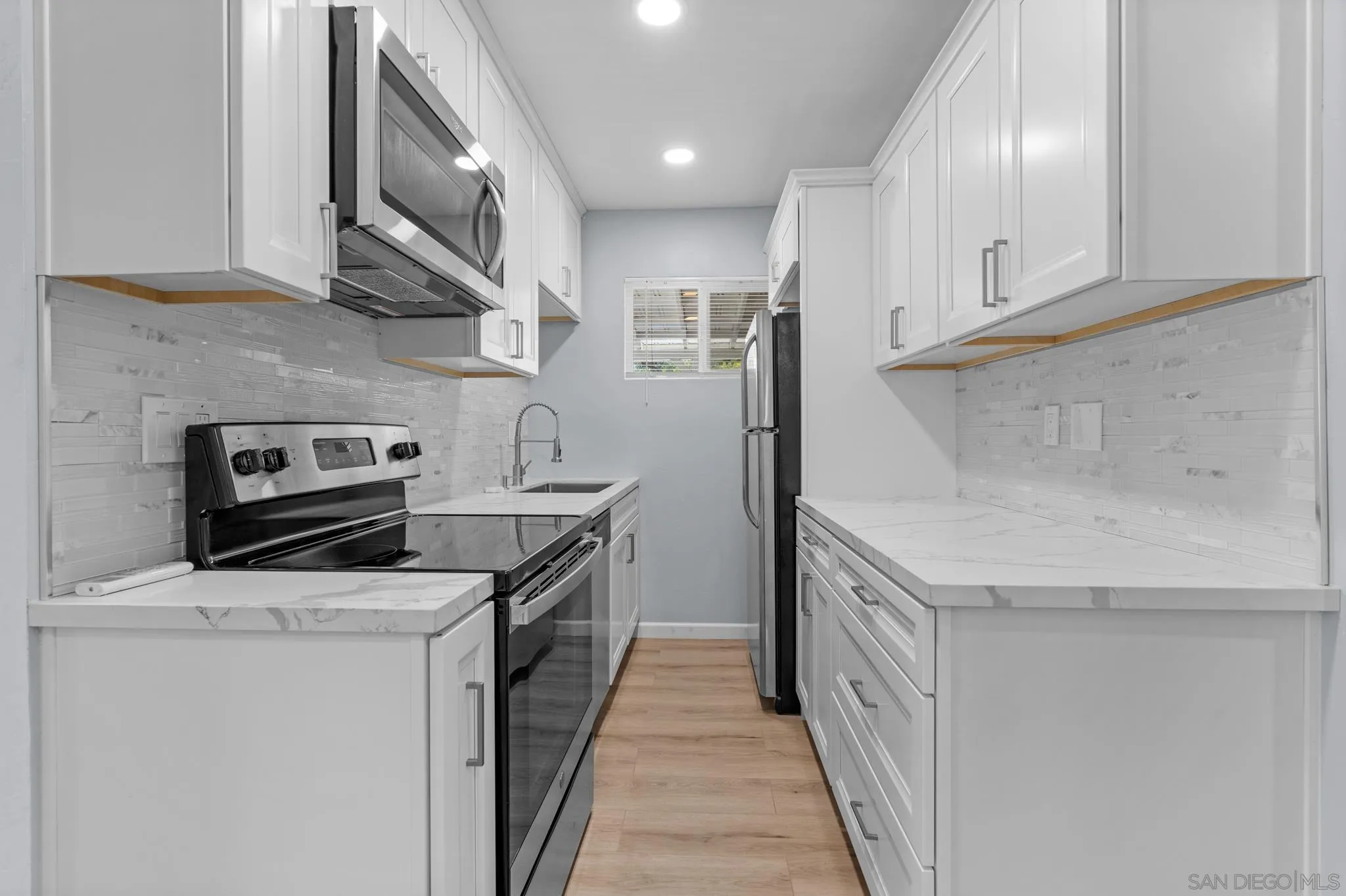 1908 Washington Street Lemon Grove, CA 91945 - Photo 27 of 54 a kitchen with stainless steel appliances granite countertop a sink and a stove