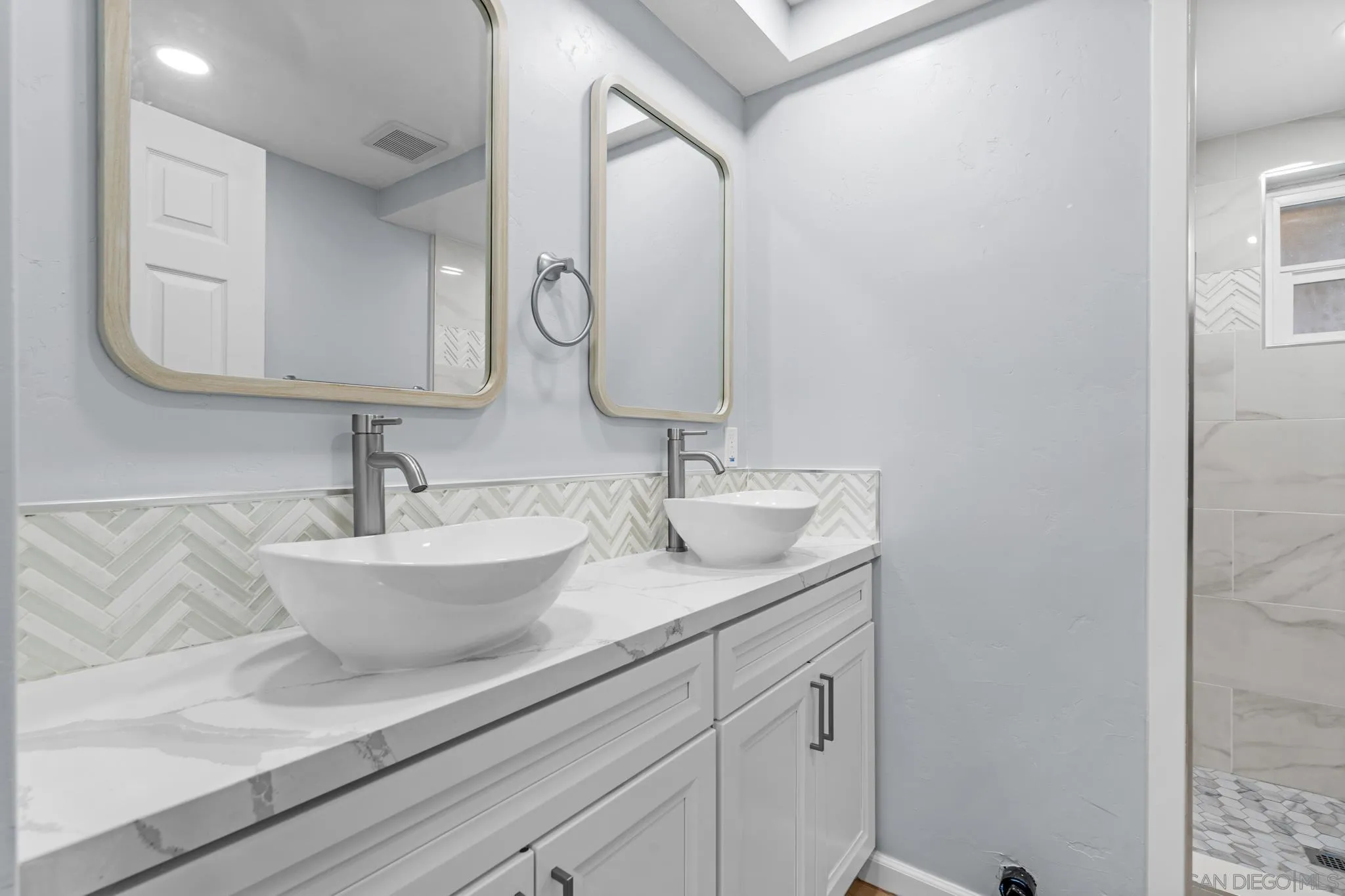 1908 Washington Street Lemon Grove, CA 91945 - Photo 29 of 54 a bathroom with a granite countertop sink and a mirror