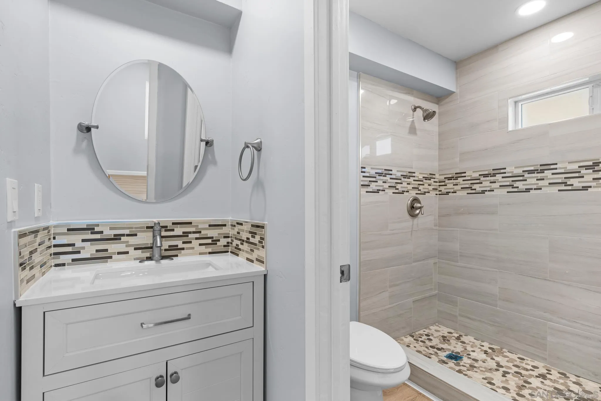 1908 Washington Street Lemon Grove, CA 91945 - Photo 31 of 54 a bathroom with a sink a toilet and shower