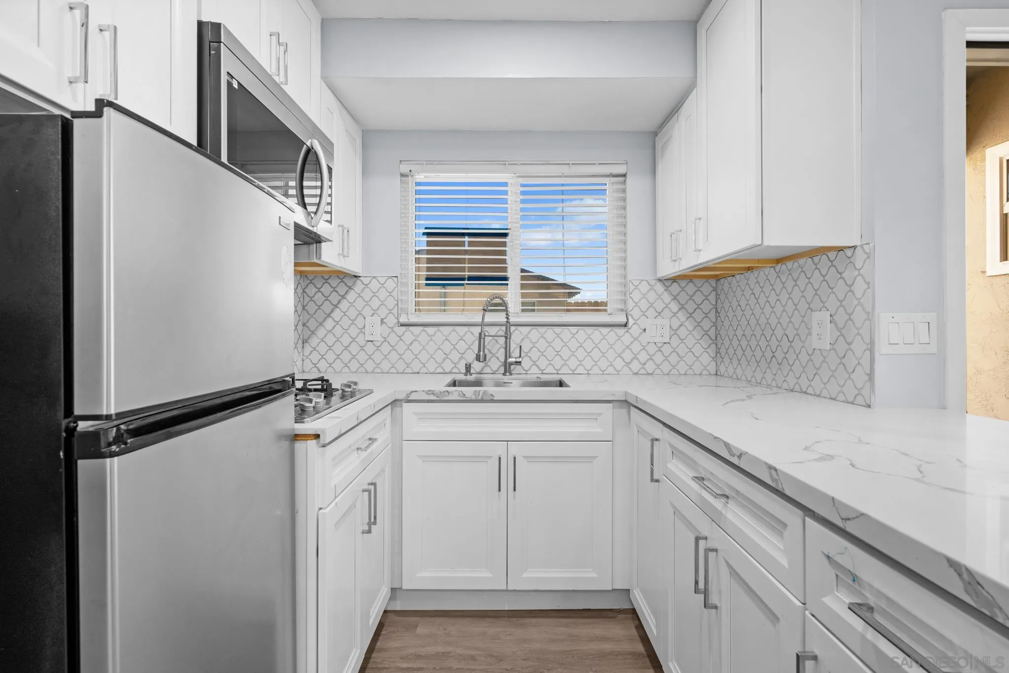 1908 Washington Street Lemon Grove, CA 91945 - Photo 37 of 54 a kitchen with a sink stove and cabinets