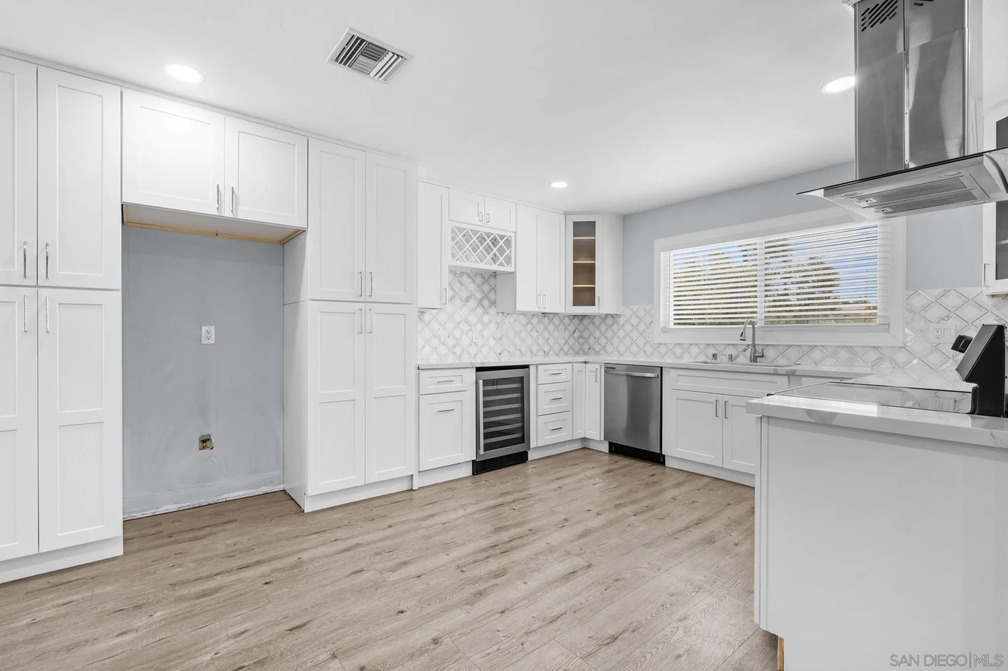 1908 Washington Street Lemon Grove, CA 91945 - Photo 10 of 54 a kitchen with stainless steel appliances a refrigerator sink and cabinets