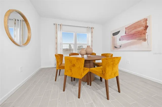 a dining room with furniture and a mirror