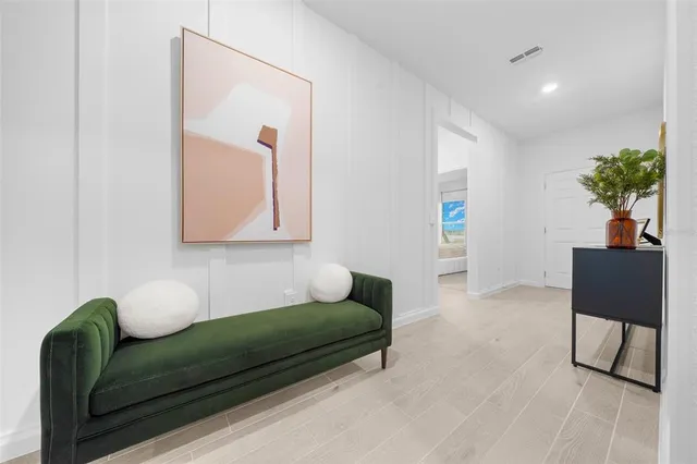 a living room with furniture and a potted plant