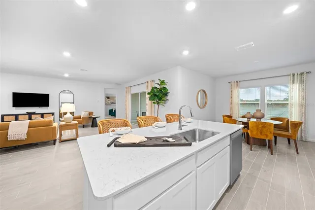 a kitchen with a refrigerator and a dining table