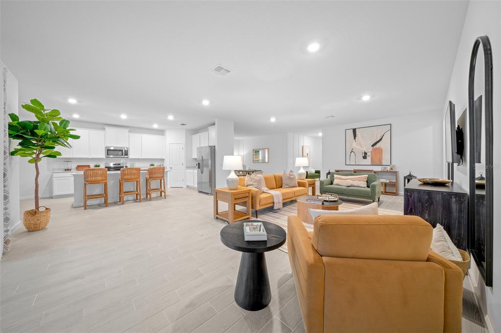 8735 Southwest 67th Circle Ocala, FL 34476 - Photo 21 of 35 a living room with furniture a refrigerator and a potted plant