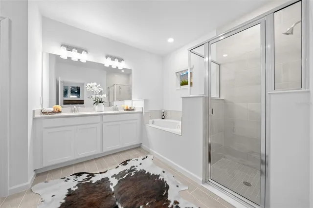 a bathroom with a double vanity sink mirror and shower