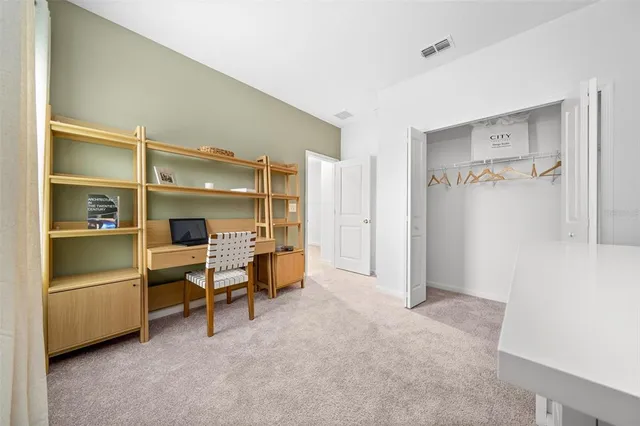 a spacious bedroom with furniture and a large window