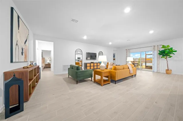 a view of a dining room with furniture and a potted plant