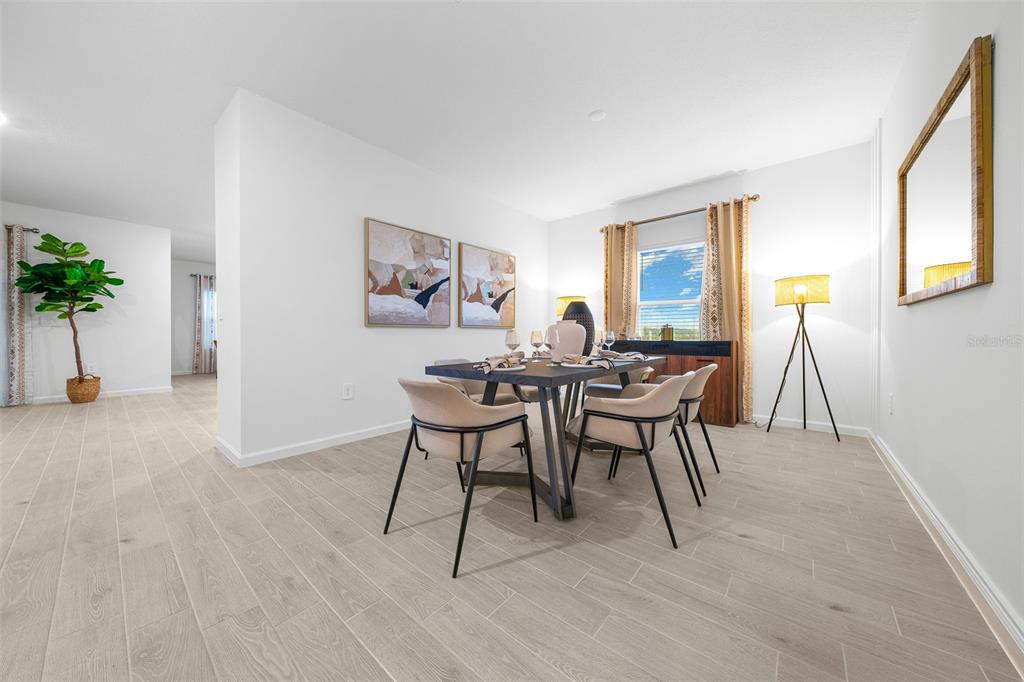 8735 Southwest 67th Circle Ocala, FL 34476 - Photo 33 of 35 a view of a dining room with furniture and a potted plant