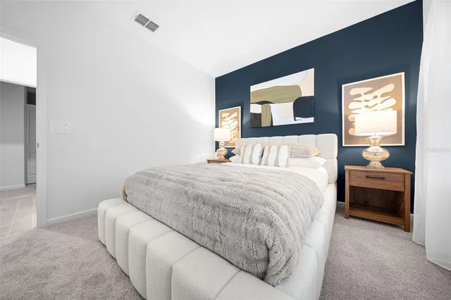 a bedroom with a bed and a couch