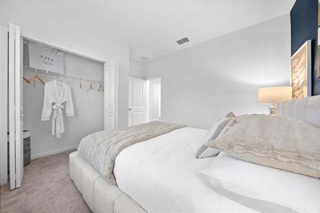 a bedroom with a bed and a mirror