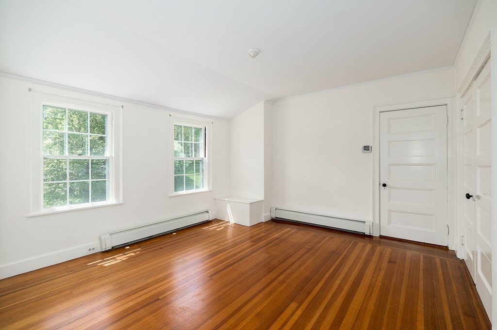 60 Walnut Road Wenham, MA 01984 - Photo 17 of 42 a view of an empty room with wooden floor and a window