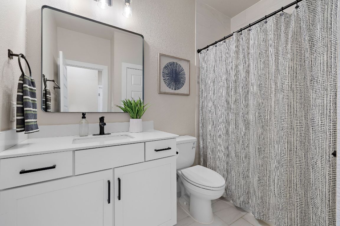 4001 Promontory Point Trail Georgetown, TX 78626 - Photo 21 of 26 Bathroom with vanity and a shower with shower curtain