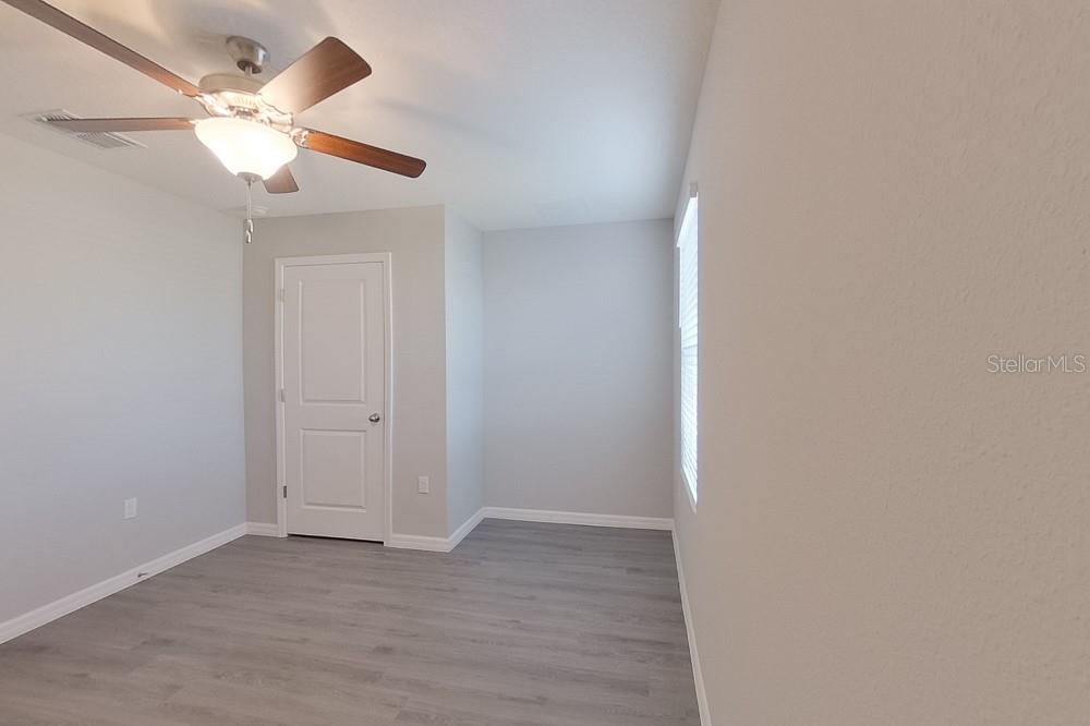 4397 Southwest 85th Lane Ocala, FL 34476 - Photo 7 of 23 an empty room with a window and a ceiling fan