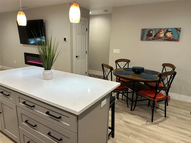 a dining room with furniture and wooden floor