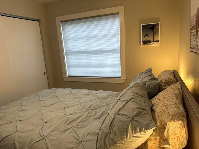 a bedroom with a bed and a window