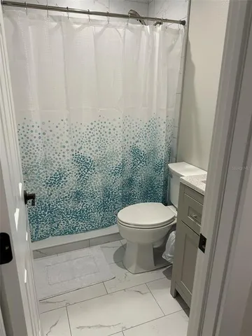 a bathroom with a shower and a toilet