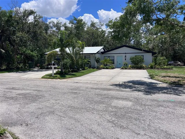 a front view of a house with a yard and a garage
