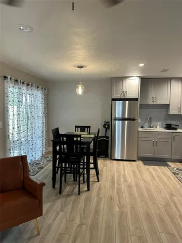a kitchen with a refrigerator a stove top oven a sink and dishwasher