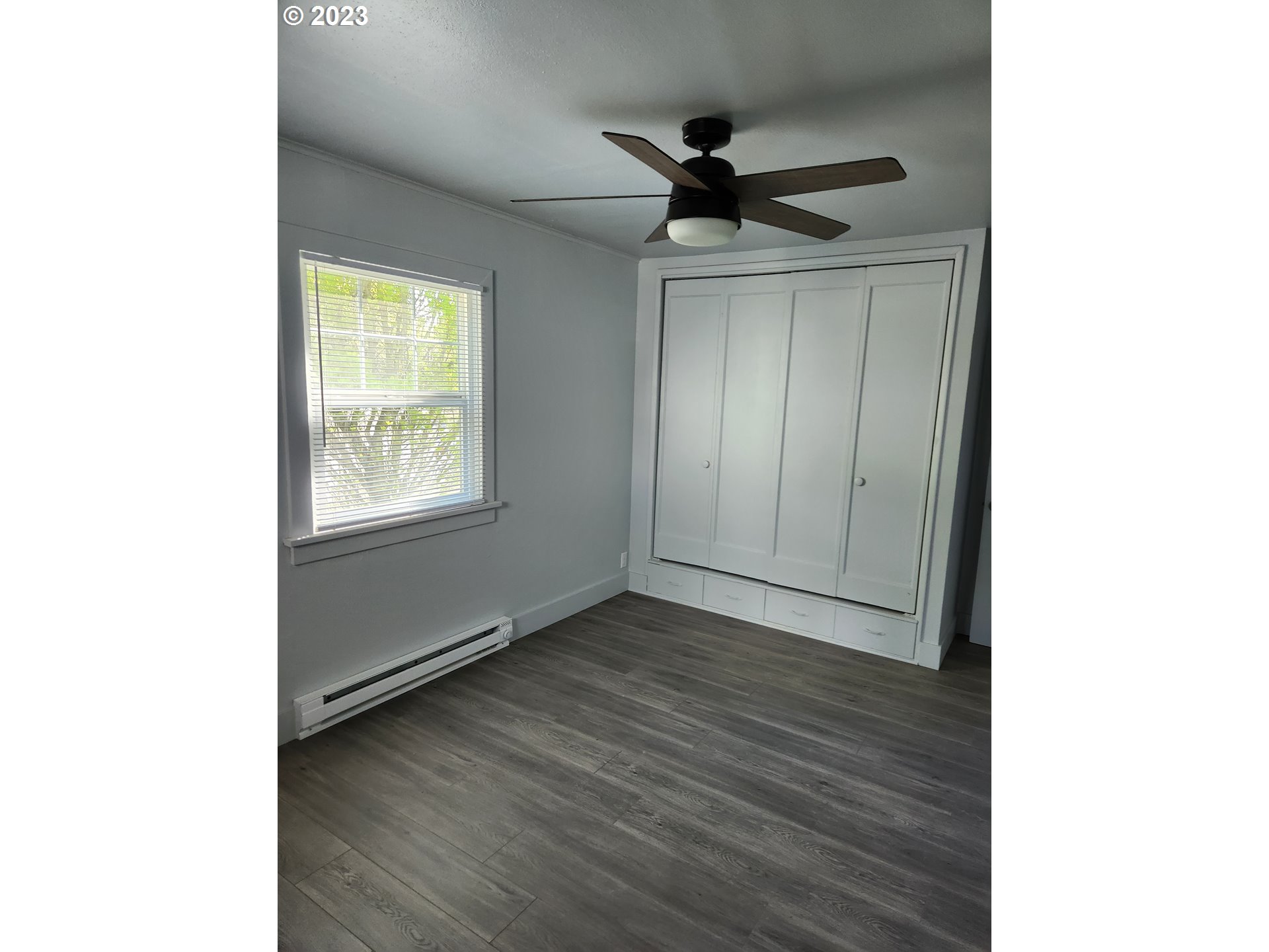 607 7th Street Springfield, OR 97477 - Photo 11 of 15 a view of empty room with wooden floor and fan