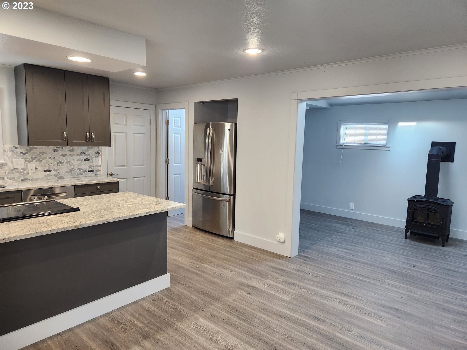 607 7th Street Springfield, OR 97477 - Photo 4 of 15 a kitchen with stainless steel appliances a refrigerator and a stove top oven