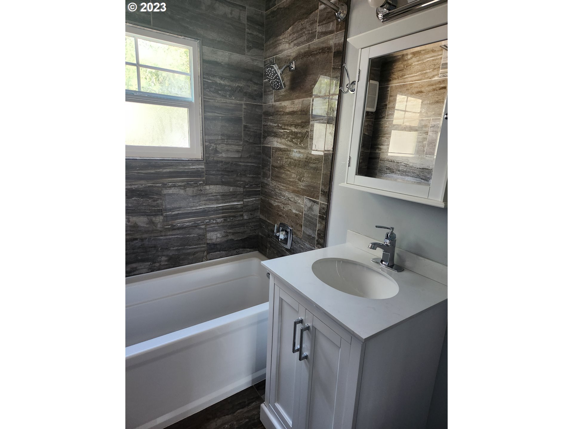 607 7th Street Springfield, OR 97477 - Photo 8 of 15 a bathroom with a sink and a bathtub