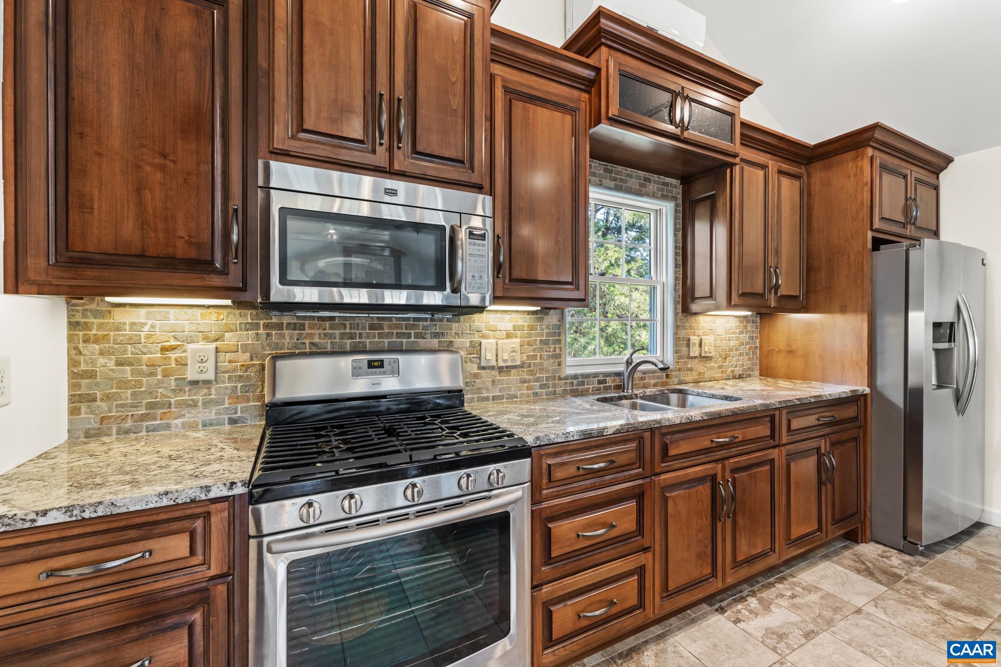 234 Creek Road Afton, VA 22920 - Photo 19 of 68 a kitchen with stainless steel appliances granite countertop wooden cabinets stove top oven and sink