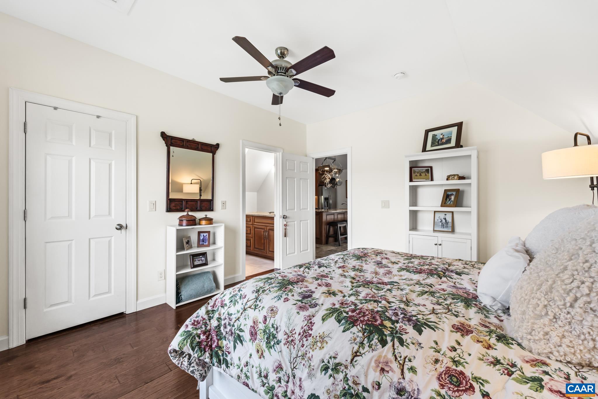 234 Creek Road Afton, VA 22920 - Photo 30 of 68 a bedroom with a large bed and a chandelier