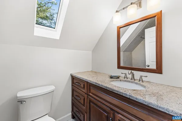 a kitchen with granite countertop a stove and a microwave