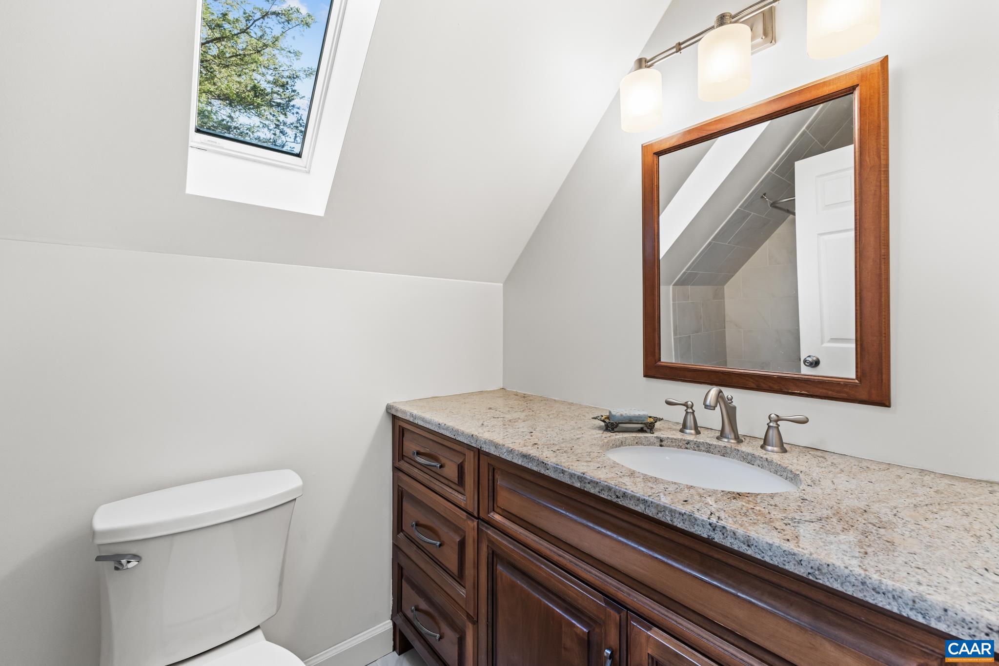 234 Creek Road Afton, VA 22920 - Photo 31 of 68 a bathroom with a granite countertop sink a mirror and a toilet