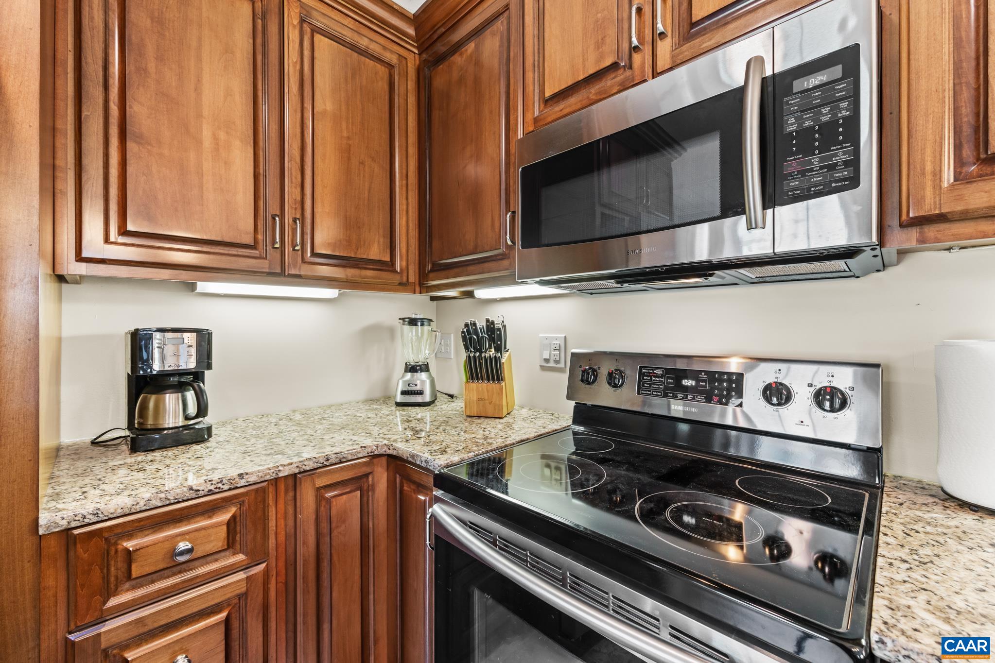 234 Creek Road Afton, VA 22920 - Photo 41 of 68 a kitchen with granite countertop a stove and a microwave