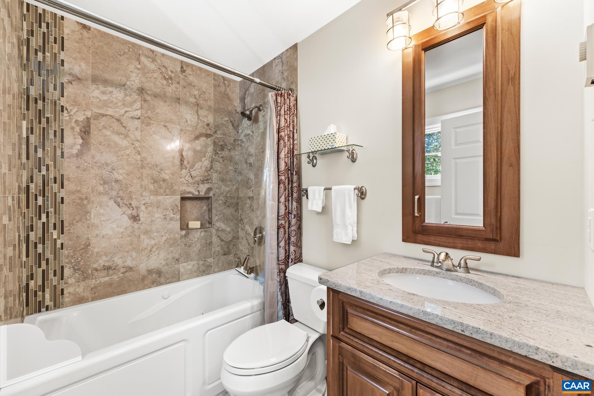 234 Creek Road Afton, VA 22920 - Photo 42 of 68 a bathroom with a granite countertop sink toilet and shower