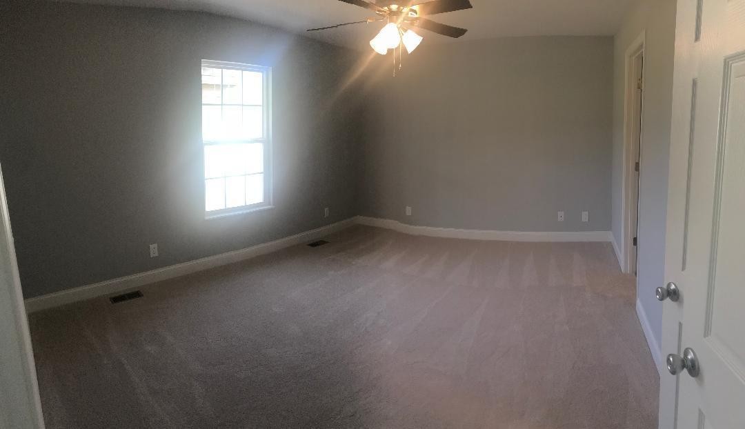 4546 Morganton Road Maryville, TN 37801 - Photo 8 of 15 en empty room with windows and chandelier fan
